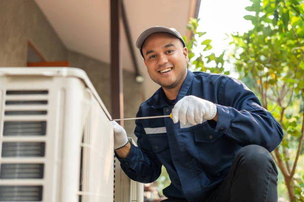 Technician inspecting an outdoor air conditioning unit